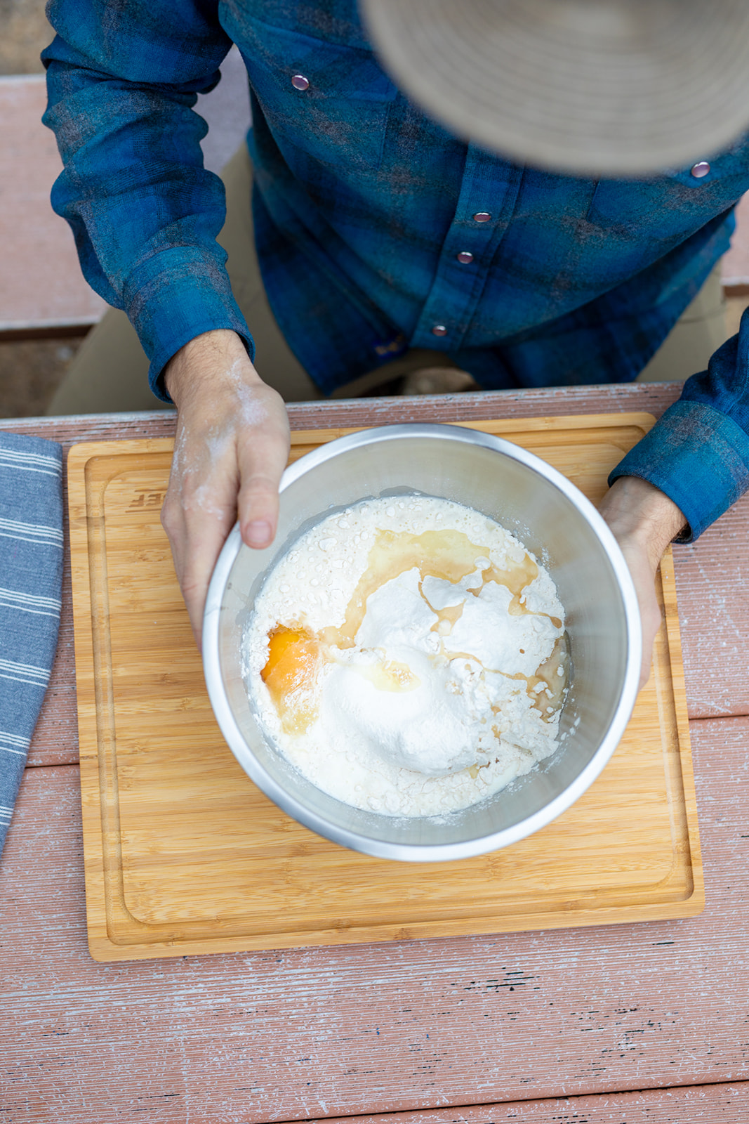 Mixing eggs and flour in a bowl for beignets. 
