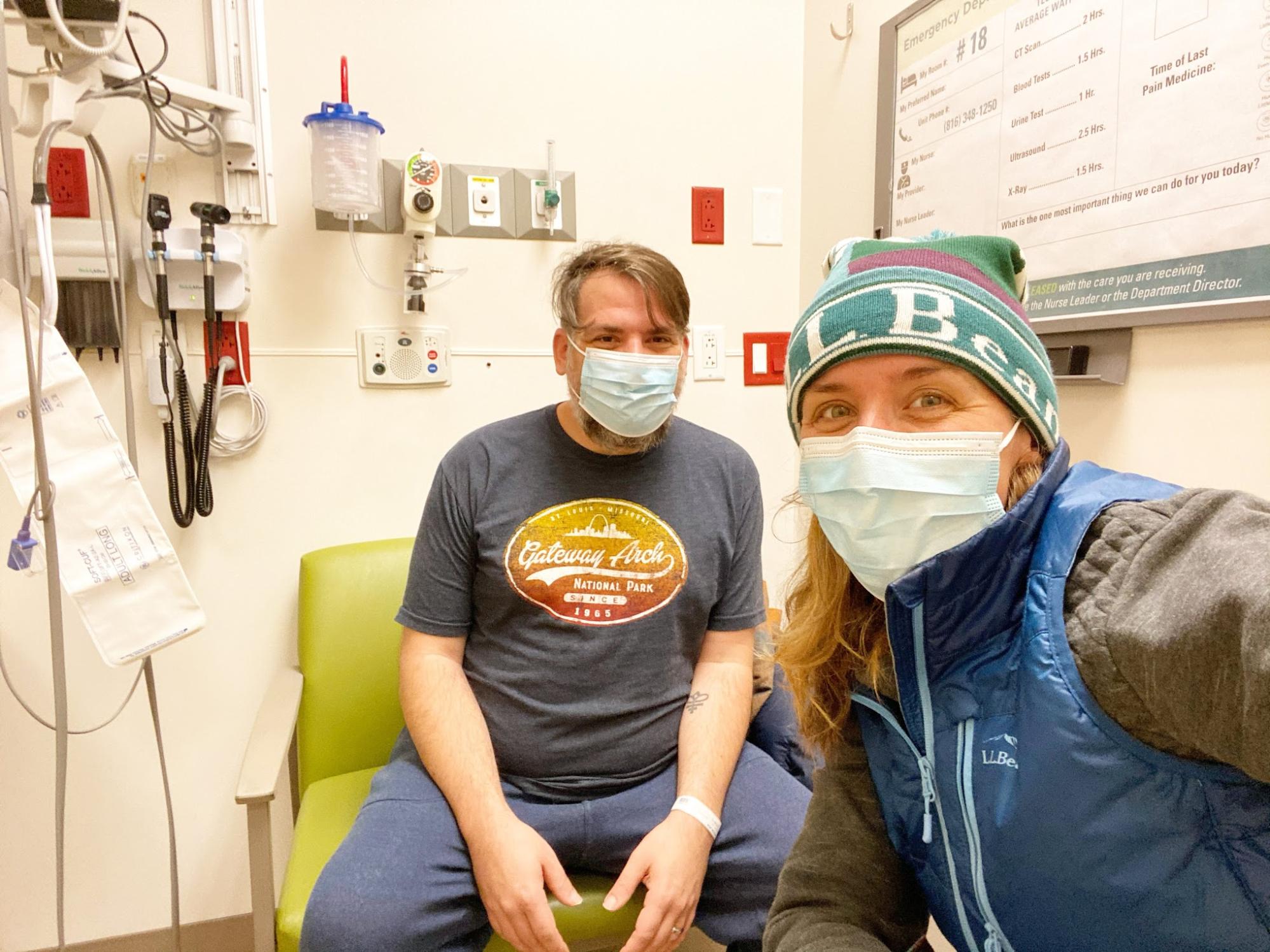 Abby Epperson and her husband smile in a hospital room.