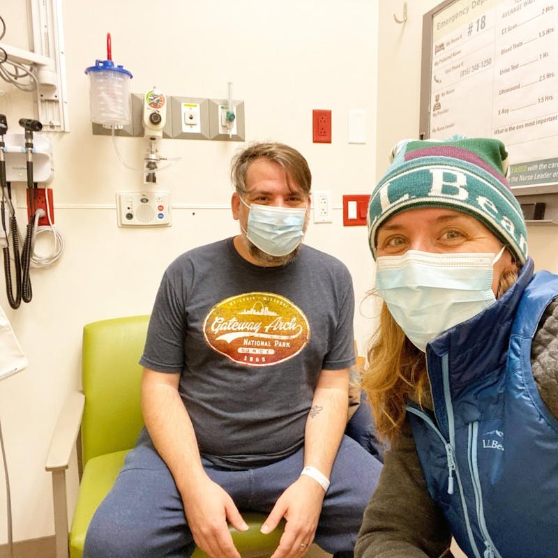 Abby Epperson and her husband smile in a hospital room.