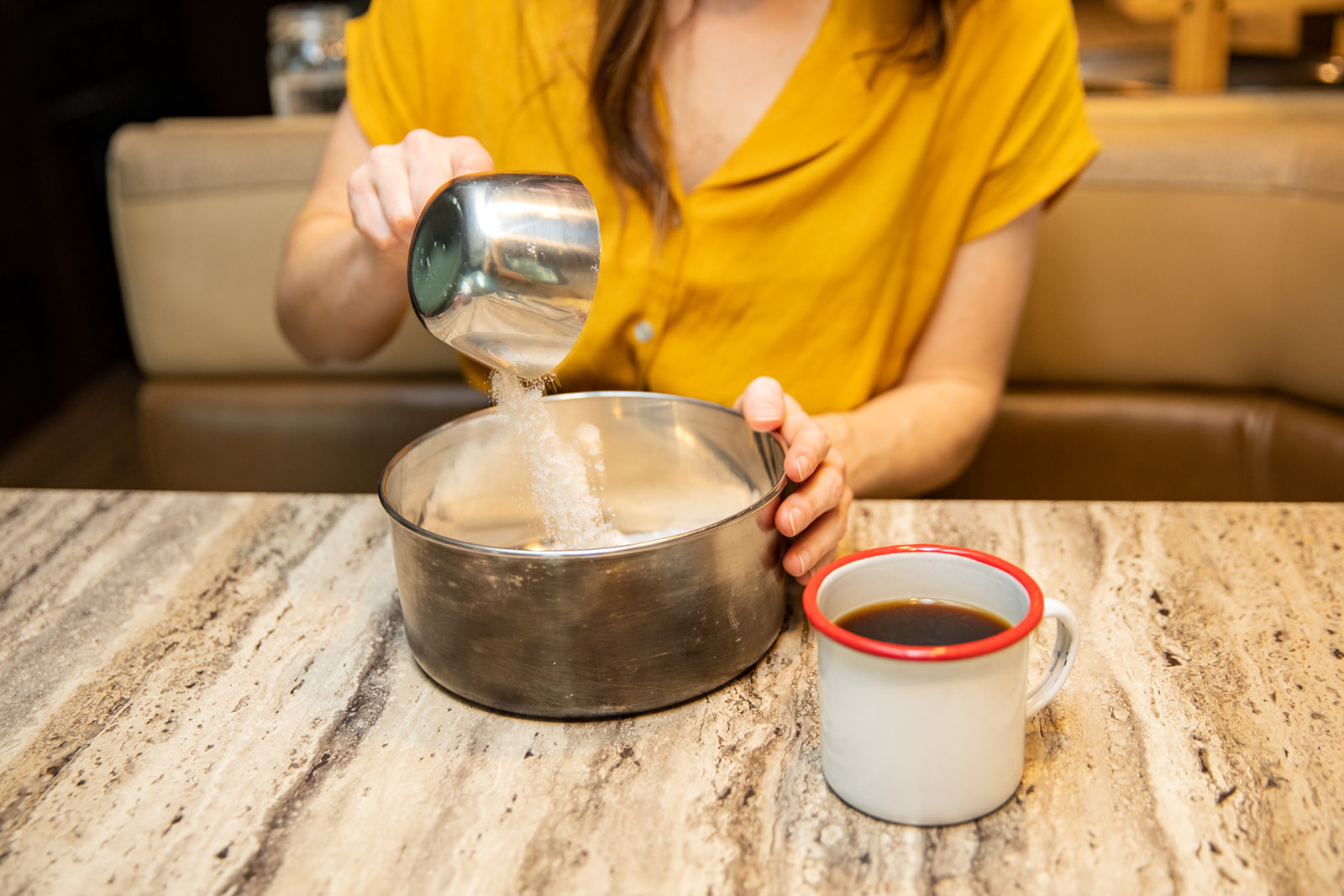 Measuring sugar into a saucepan. 