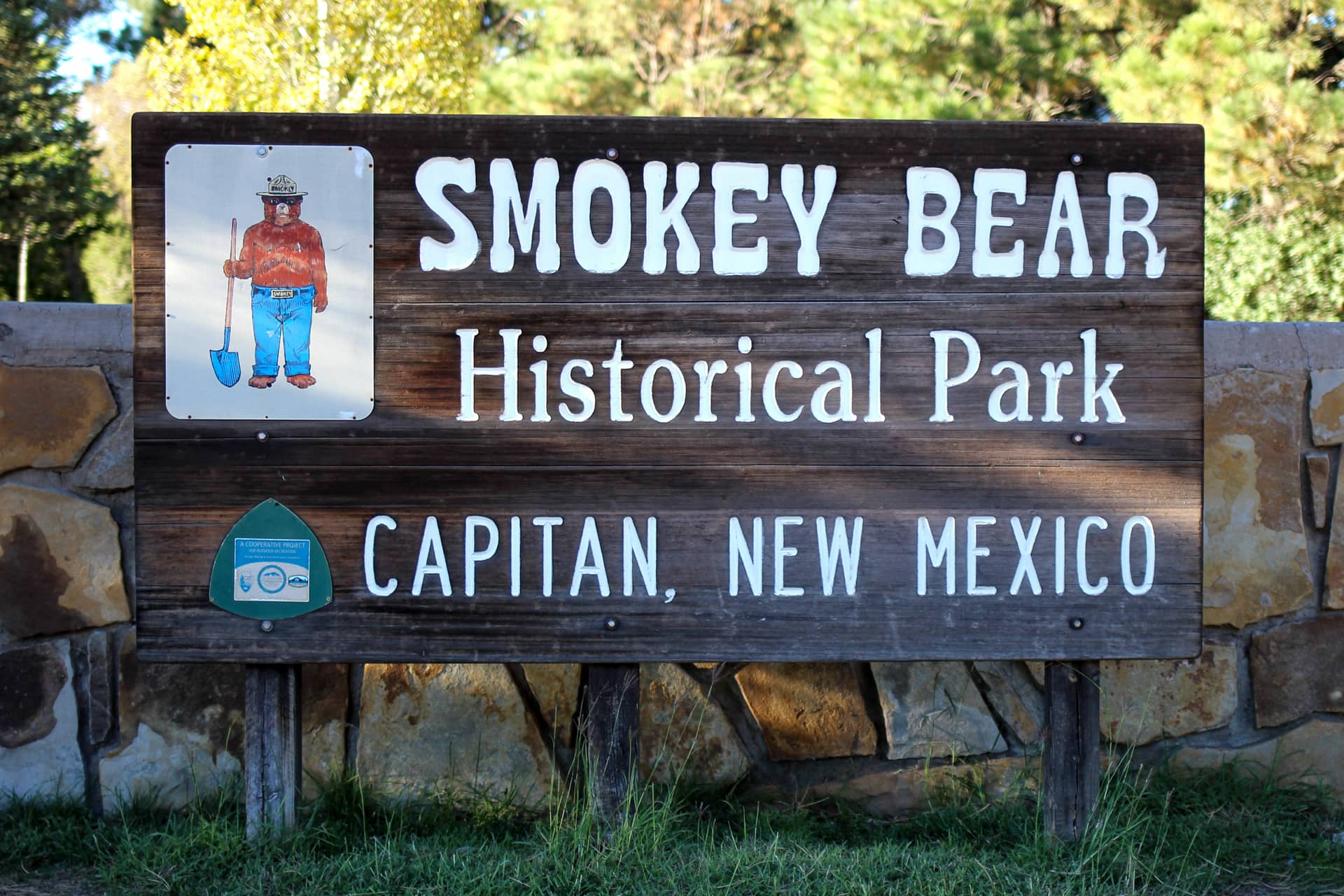 Dark wooden sign for Smokey Bear Historical Park in Capitan, New Mexico