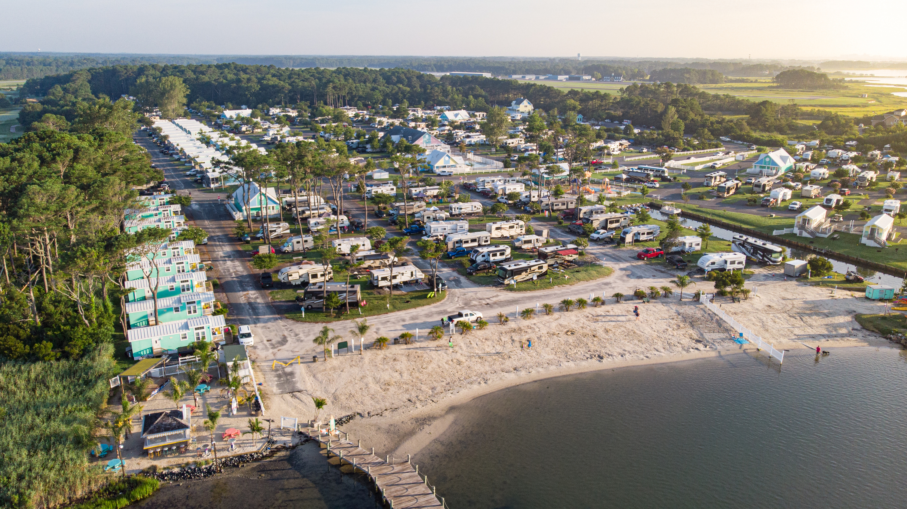 An aerial shot of an RV park near the beach. 