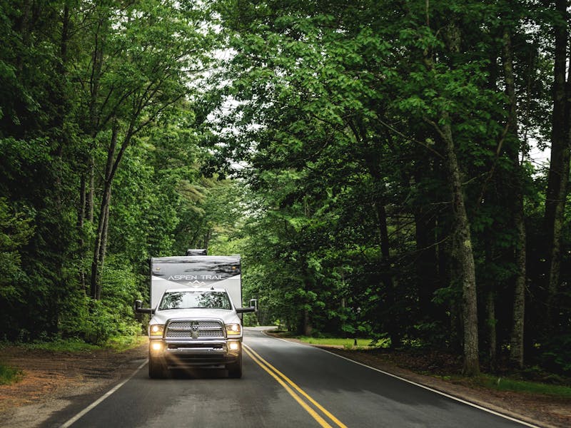 A dutchmen Aspen Trail driving down the road