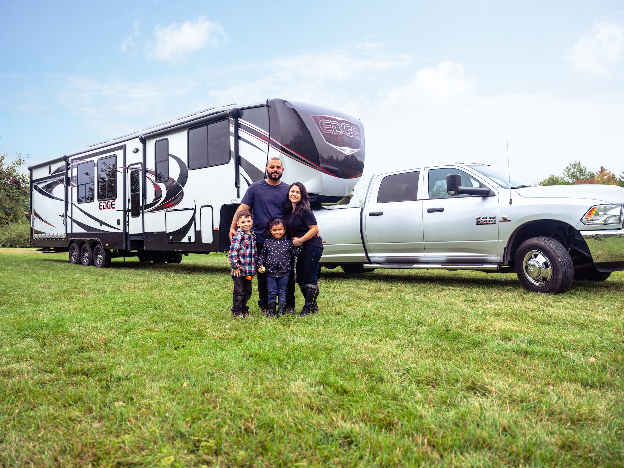 The Class Family posed outside with their toy hauler RV. 
