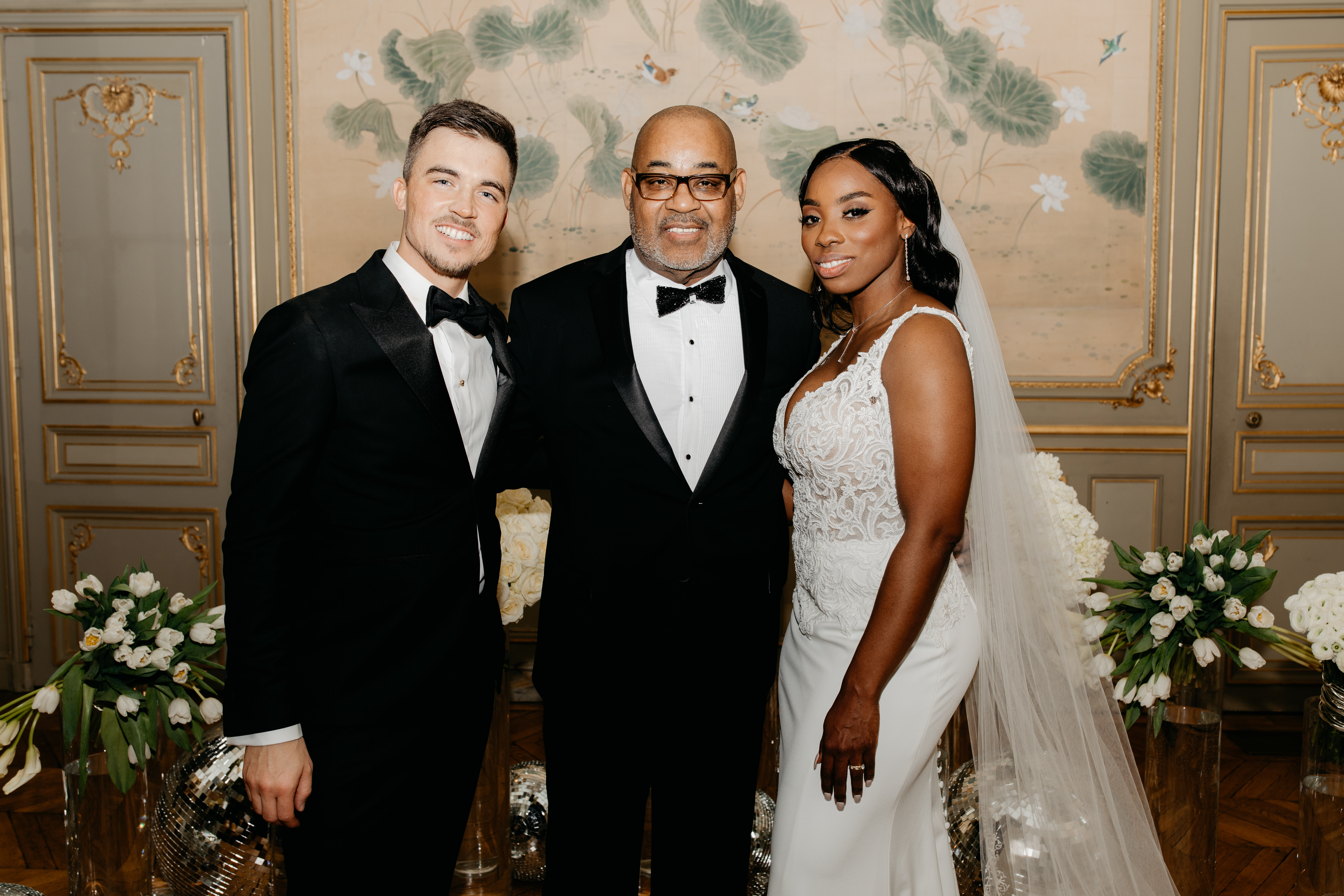 Jessy and Jim McFarlin post for a picture with Jessy's dad on their wedding day.