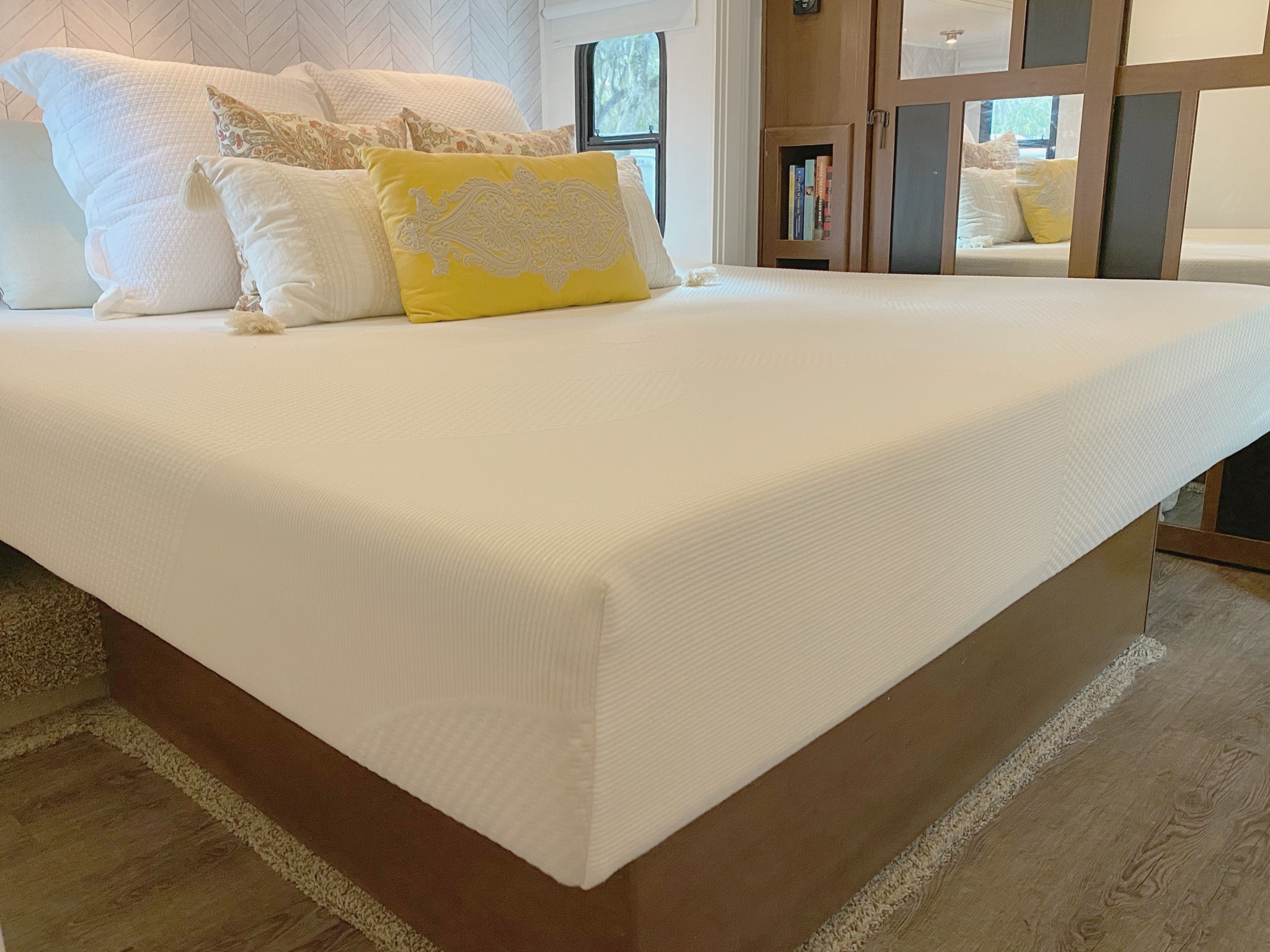 A king-sized memory foam mattress in an RV bedroom. 