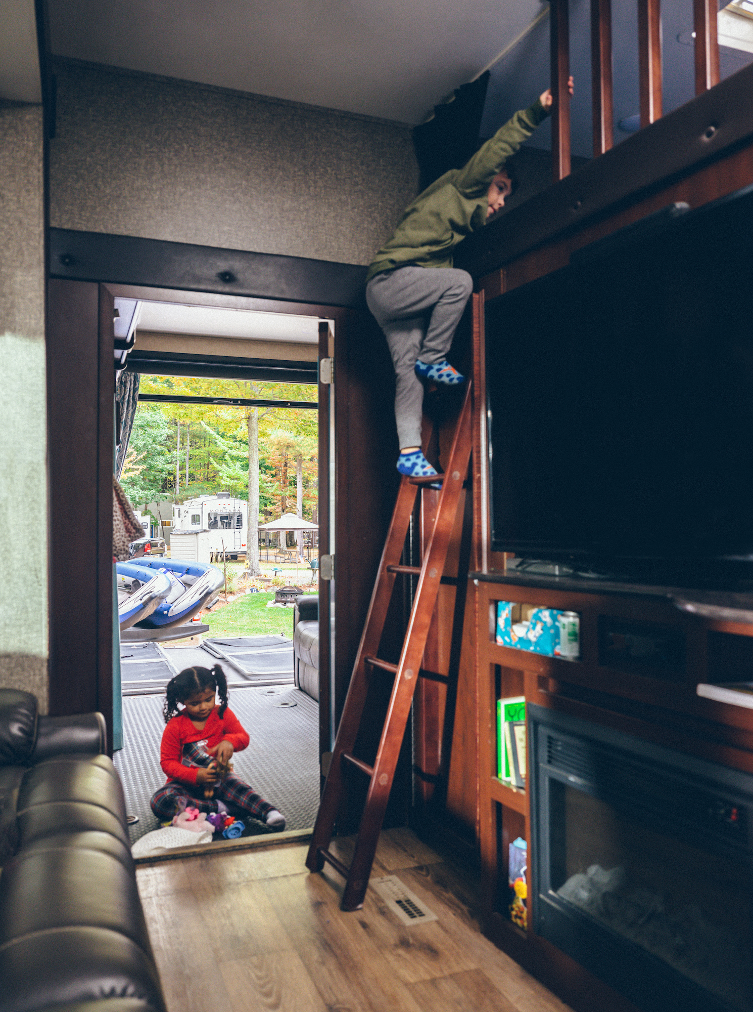Julian climbing down from a bunkbed to go play outside.
