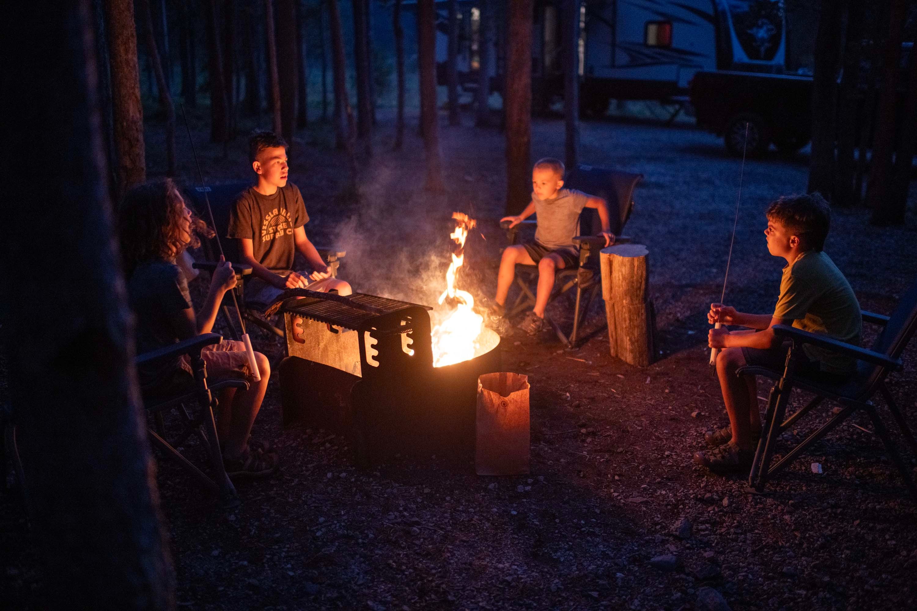The Chelsea Day family sitting around a campfire at Sawtooth National Forest