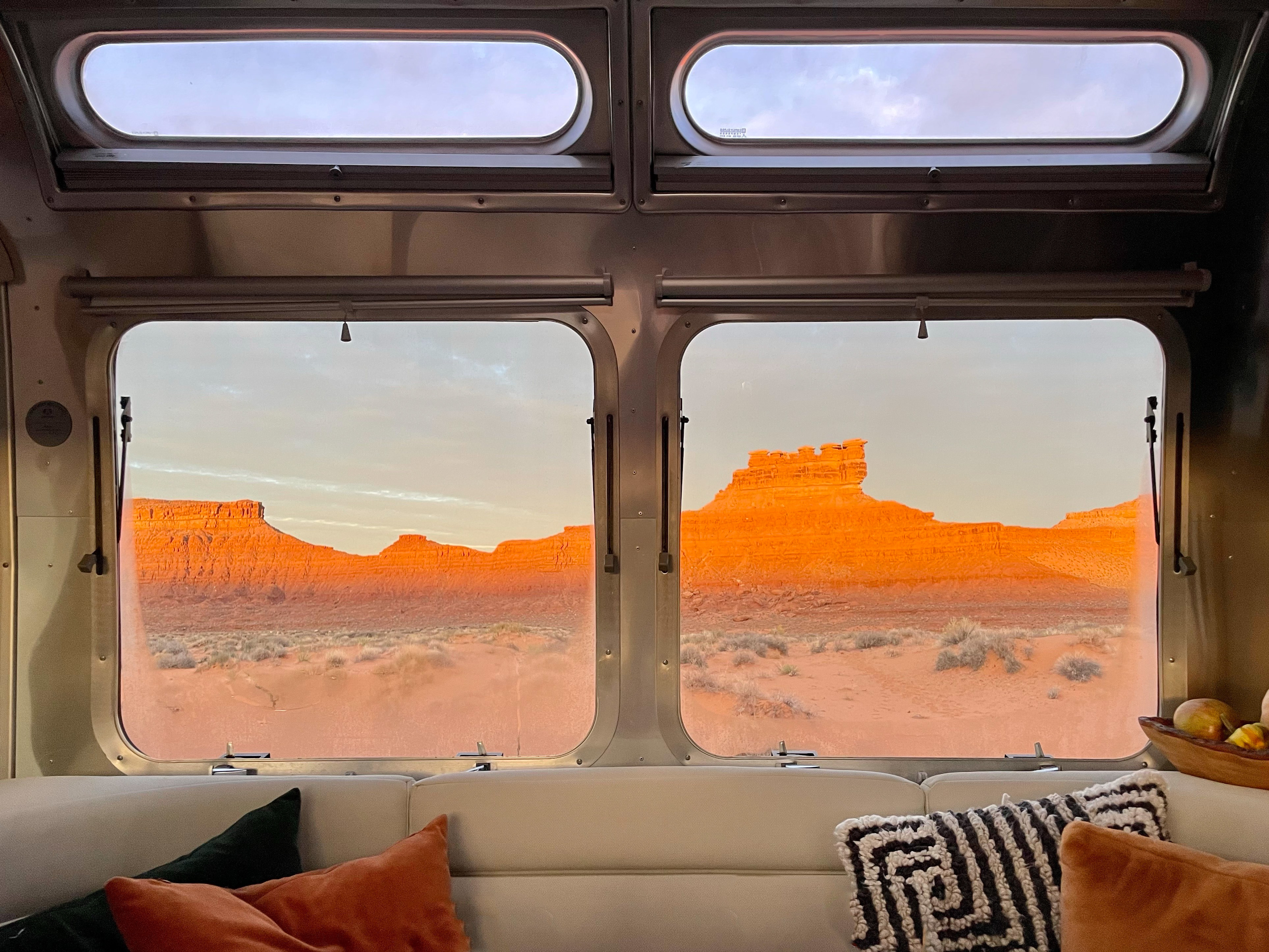 Looking out the window of Karen and Lenny Blue's Airstream Flying Cloud at a desert landscape