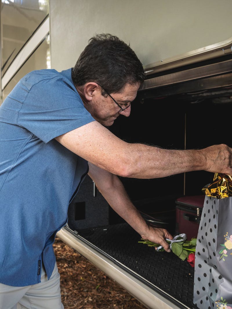 A man pulling a gift out of an RV