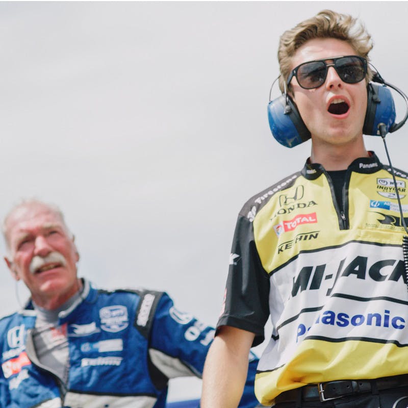 Takuma Sato's pit crew and coaches watch as he races in the Indy 500.