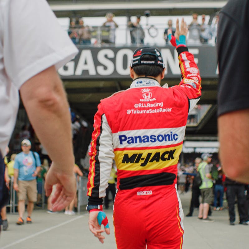 Takuma Sato waves to fans at the 2019 Indy 500.