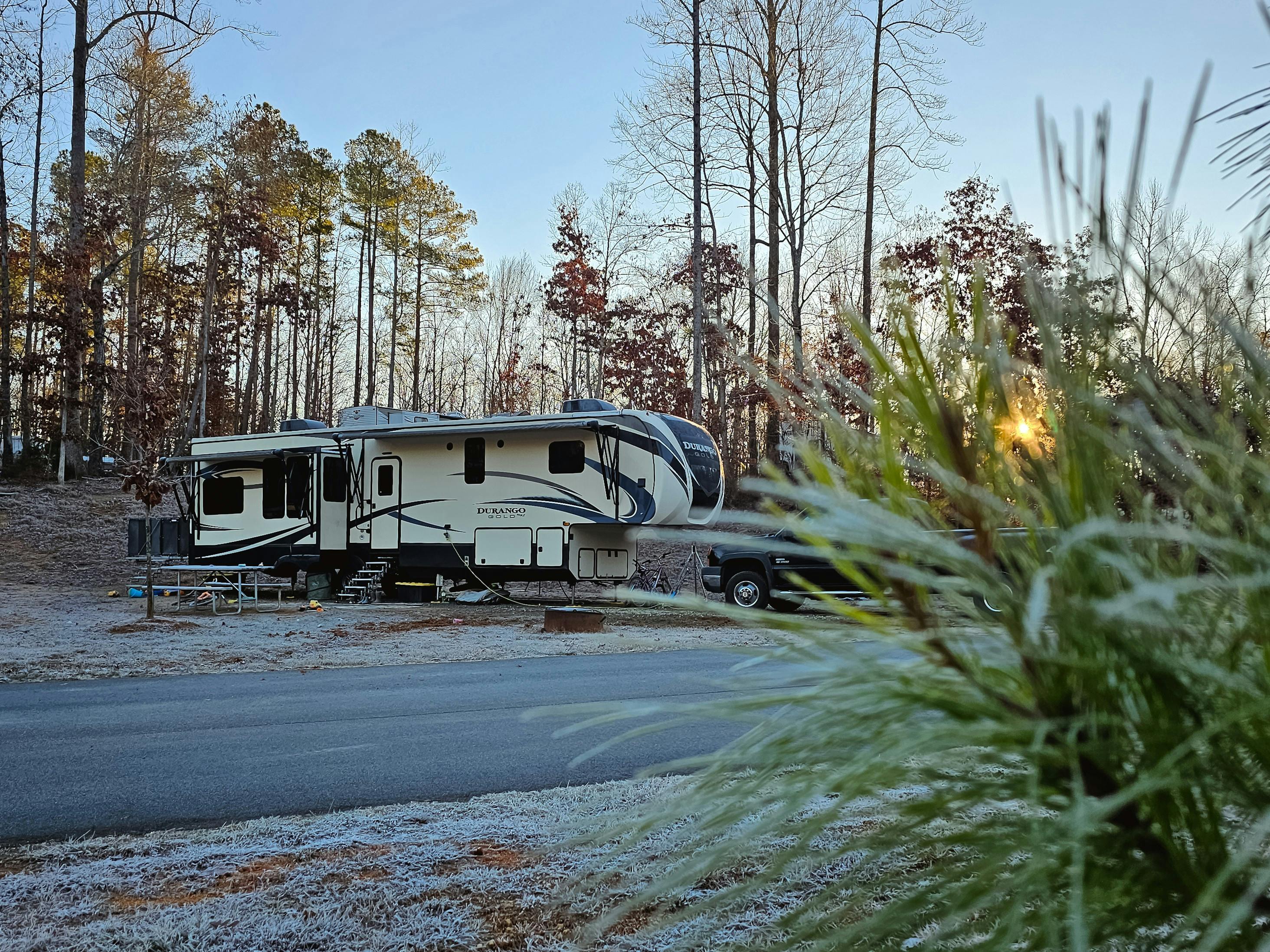 Bibi and JC Barringer's KZ Durango Gold parked at a campsite on a crisp morning.