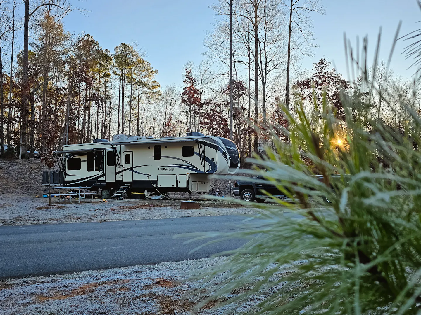 Bibi and JC Barringer's KZ Durango Gold parked at a campsite on a crisp morning.