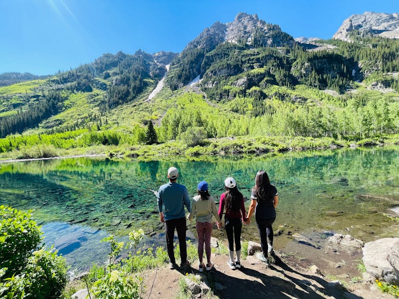 Brenda Huynh & Tiger Doan and their family looking out at a lake landscape
