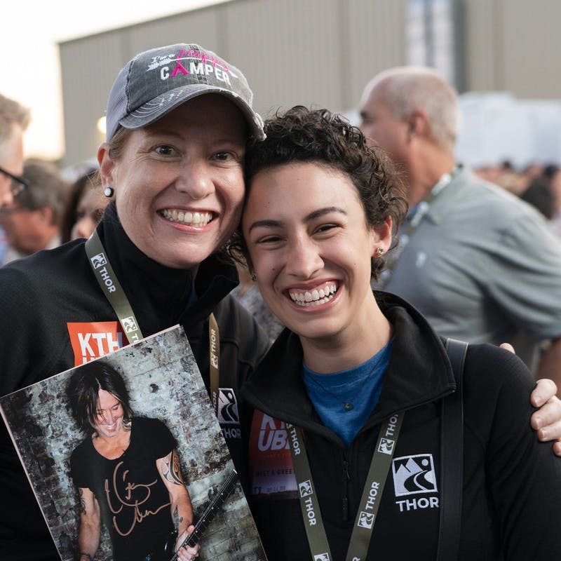 First Descents participants pose with signed Keith Urban photographs.