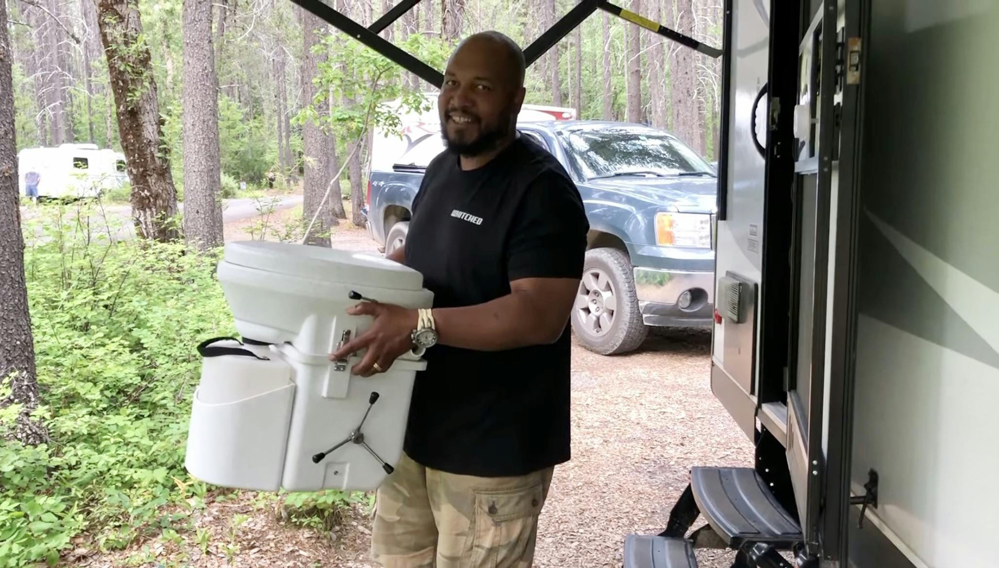 Ben McMillan holding his composting toilet