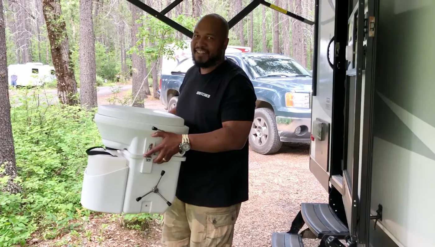 Ben McMillan holding his composting toilet