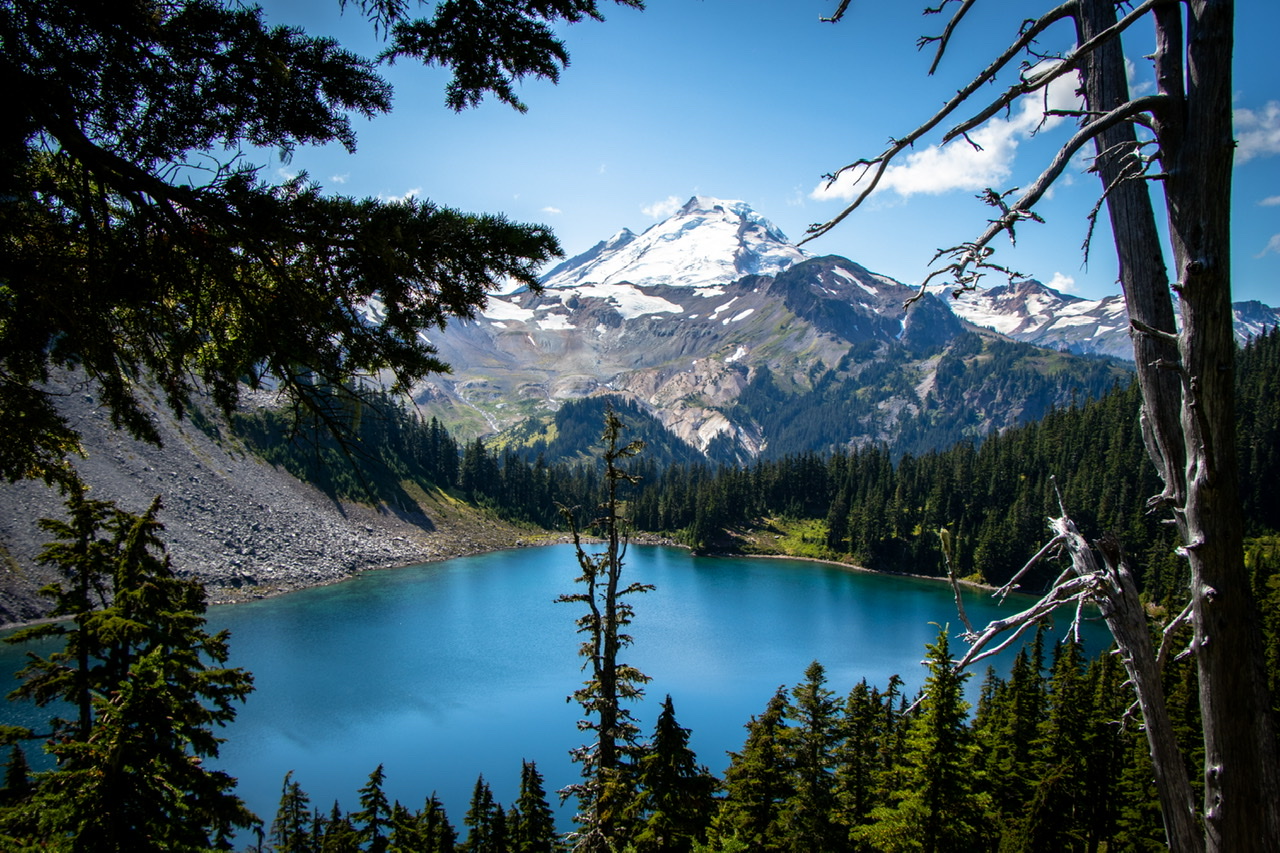 A lake in front of a mountain in Mt. Baker National Forest