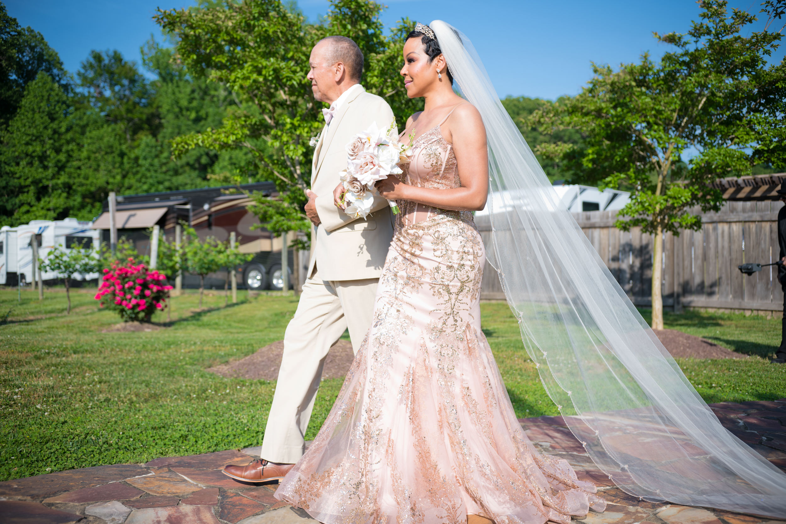 Sonya's father walks her down the aisle at her wedding. 