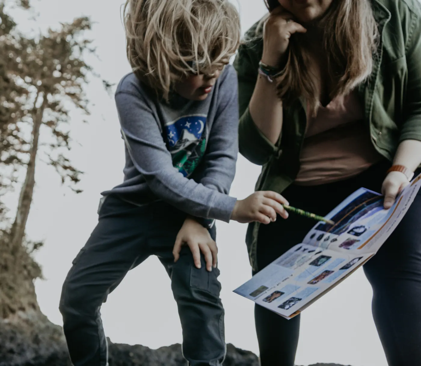 Kristen Murphy and her child learning about tide pools with a guide book