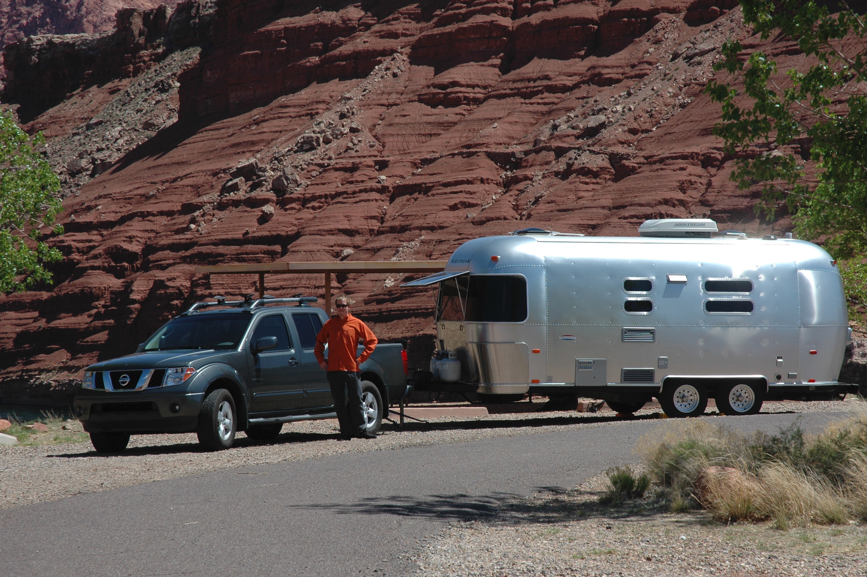 James posed with his truck and Airstream next to some red rock cliffs.