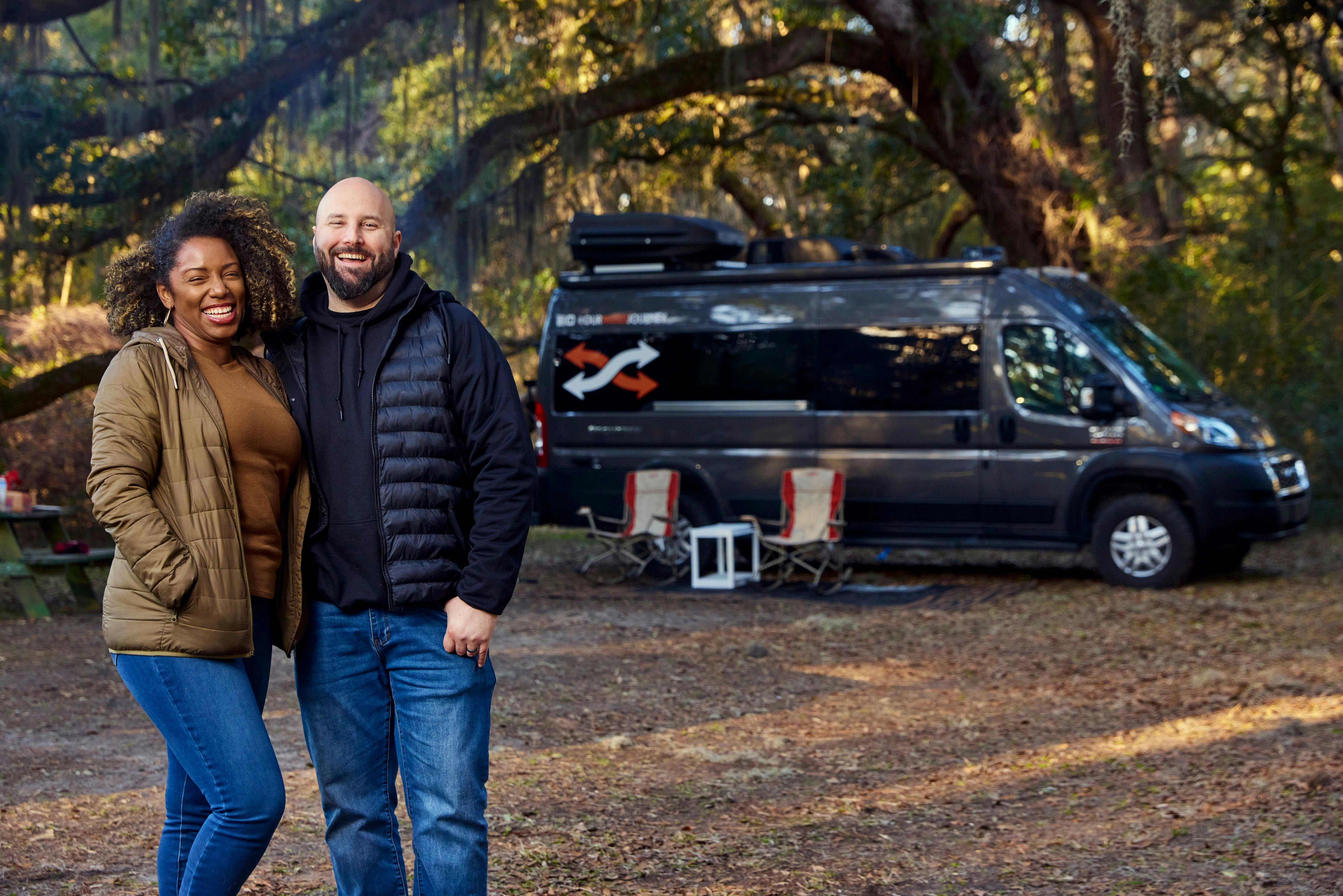 Gabe and Rocio Rivero smiling for a portrait in front of their Thor Motor Coach Sequence Class B Camper Van