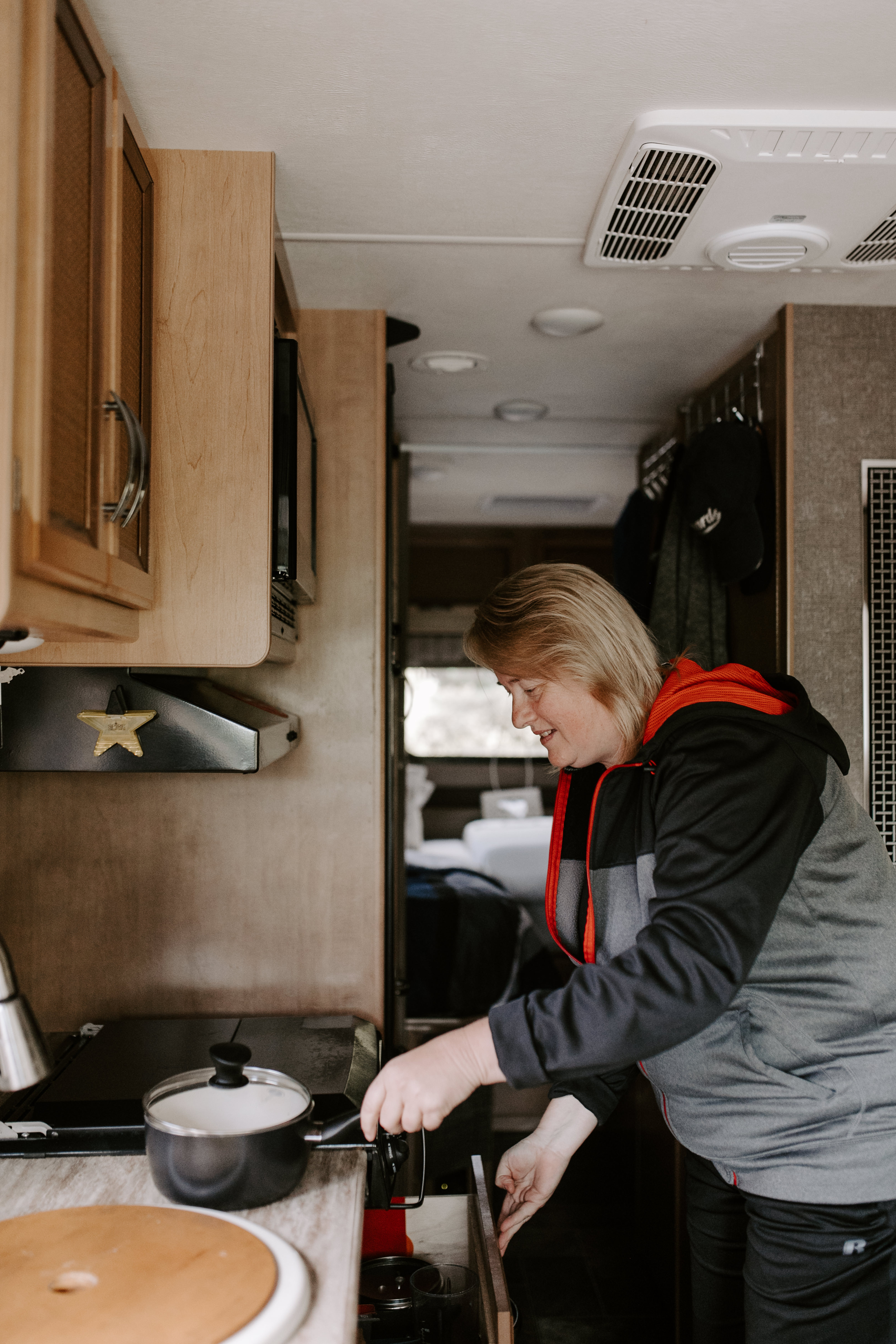 Kathy cooking inside her RV kitchen. 