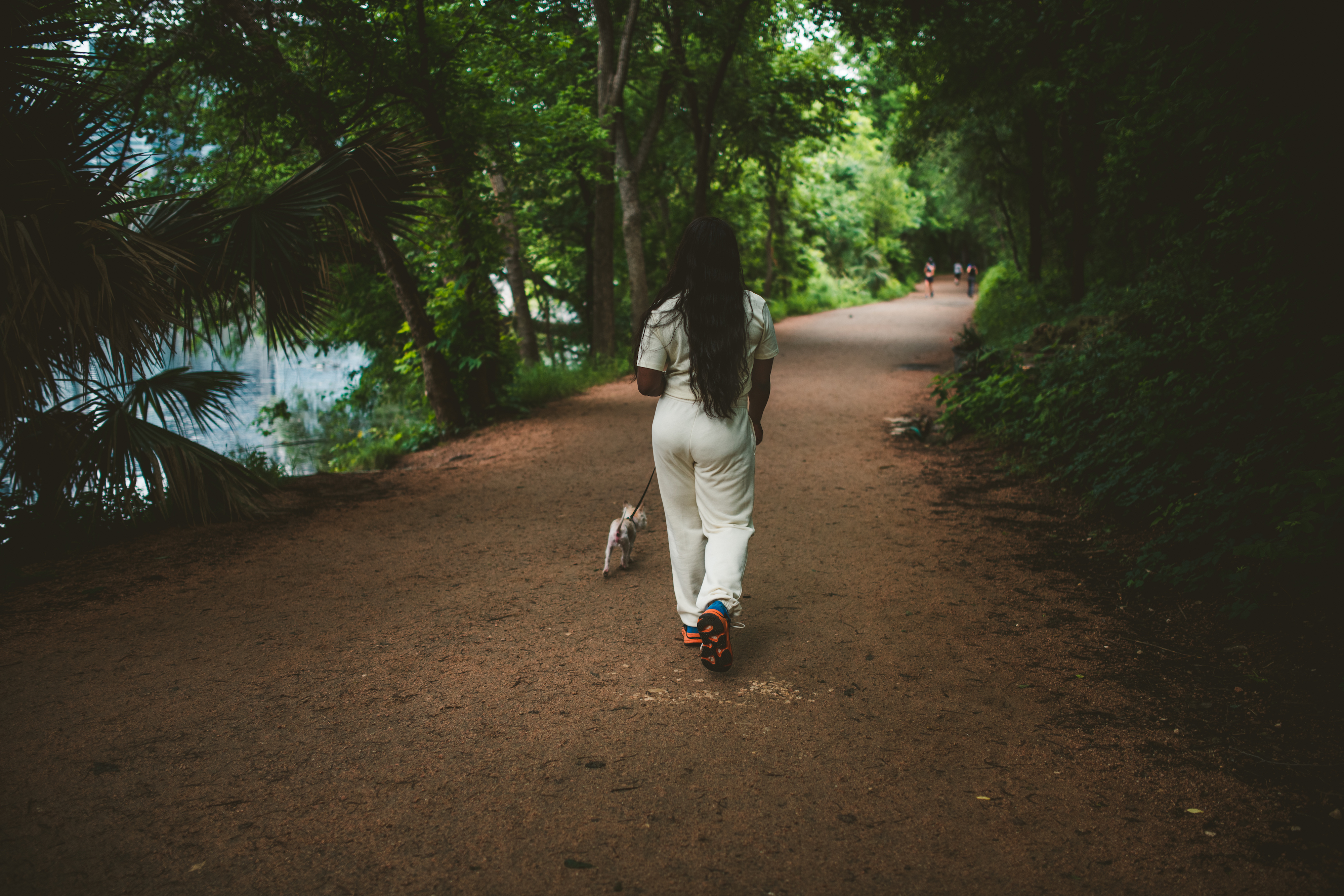 Jessy walking her dog Tiny through a park in Austin, Texas