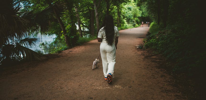 Jessy walking her dog Tiny through a park in Austin, Texas