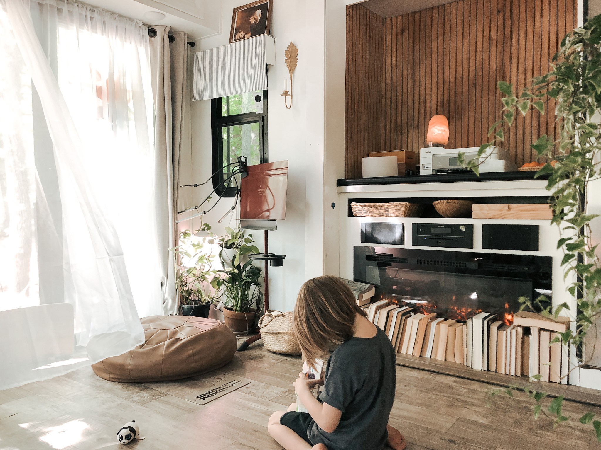 Bibi BARRINGER's child playing in front of their fireplace in their RV