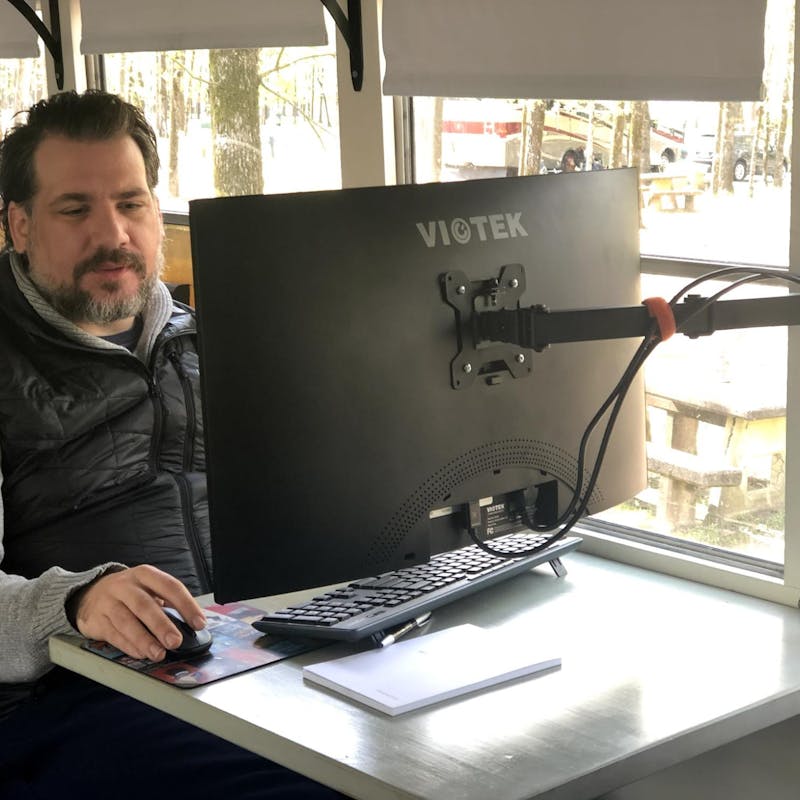 Abby Epperson's husband doing work at a computer inside their Heartland Pioneer.