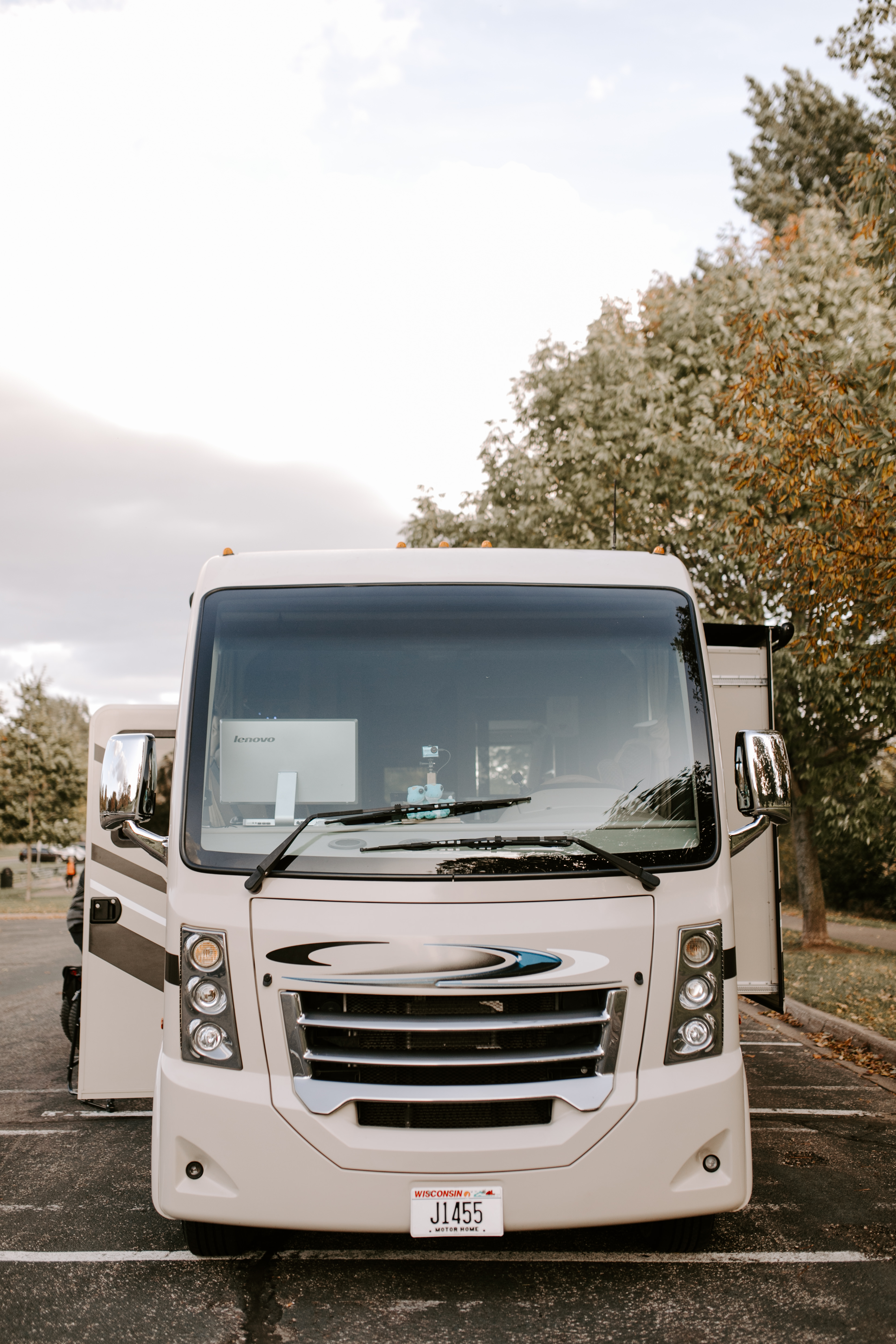 A front shot of a Class A RV with its slides out. 