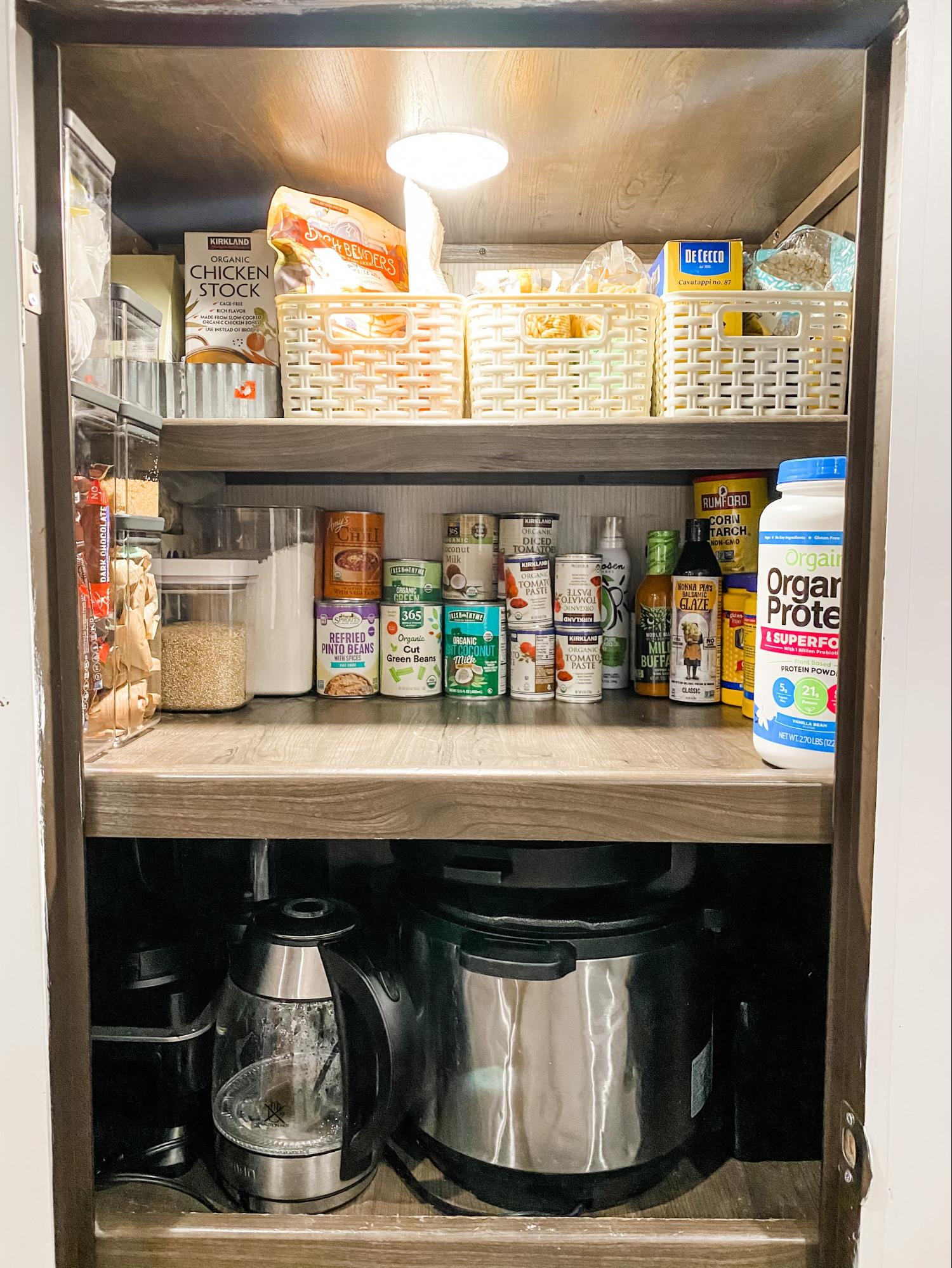 A shot of Brittnee Proha's pantry that is organized using pull out baskets to optimize storage in her Heartland Cyclone. 