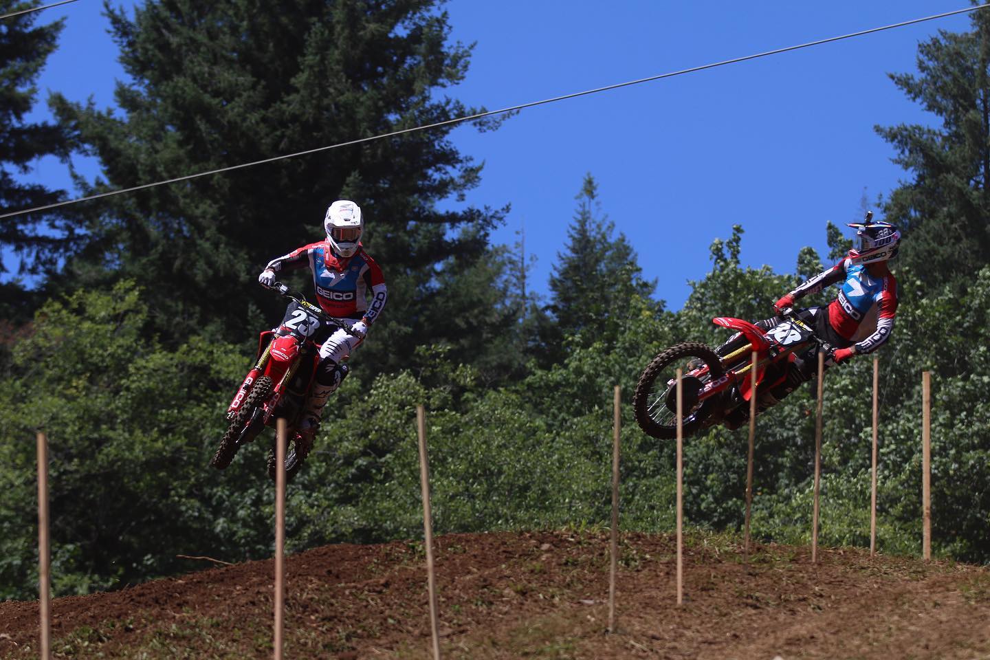 Two dirt bike riders getting air at Washougal Motocross Park. 