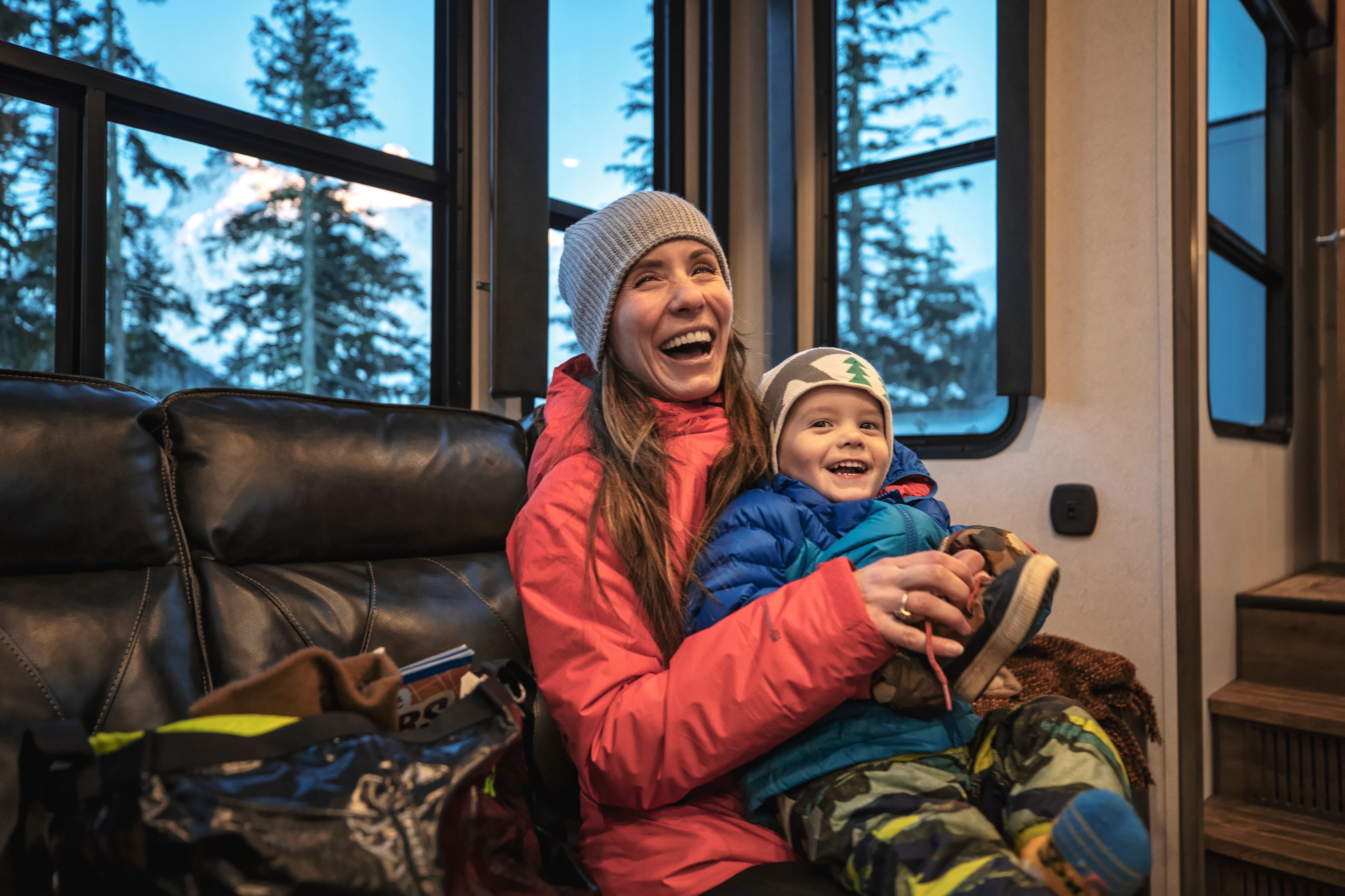Shannon Mahre and her son sitting on the couch of their Keystone Fifth Wheel