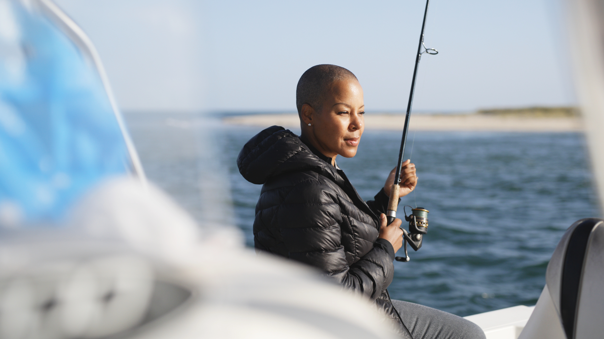 Sonya Lowery holding a fishing pole on a deep sea fishing trip in Cape Cod.