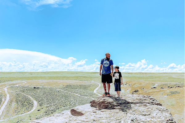Justin Russell holds his son's hands while on a hike.