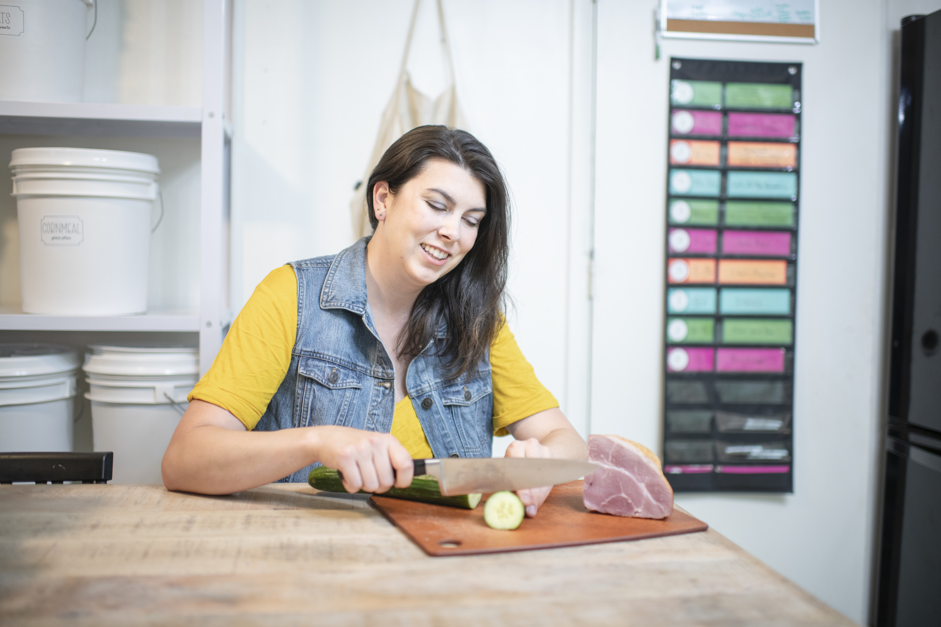 Chelsea Day chopping a cucumber in the kitchen of her Highland Ridge RV.