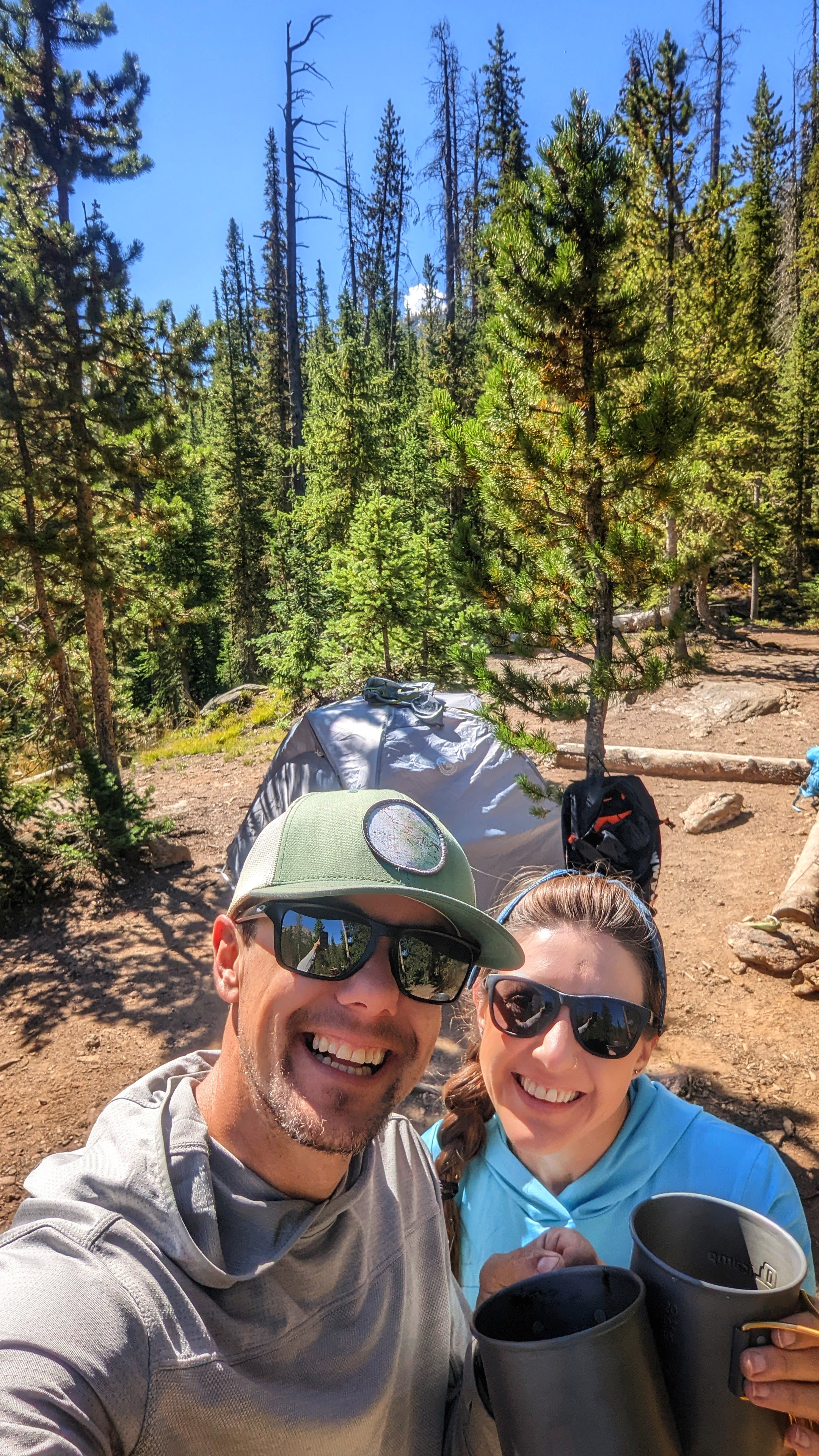 Dustin and Sarah Bauer taking a selfie in front of their tent