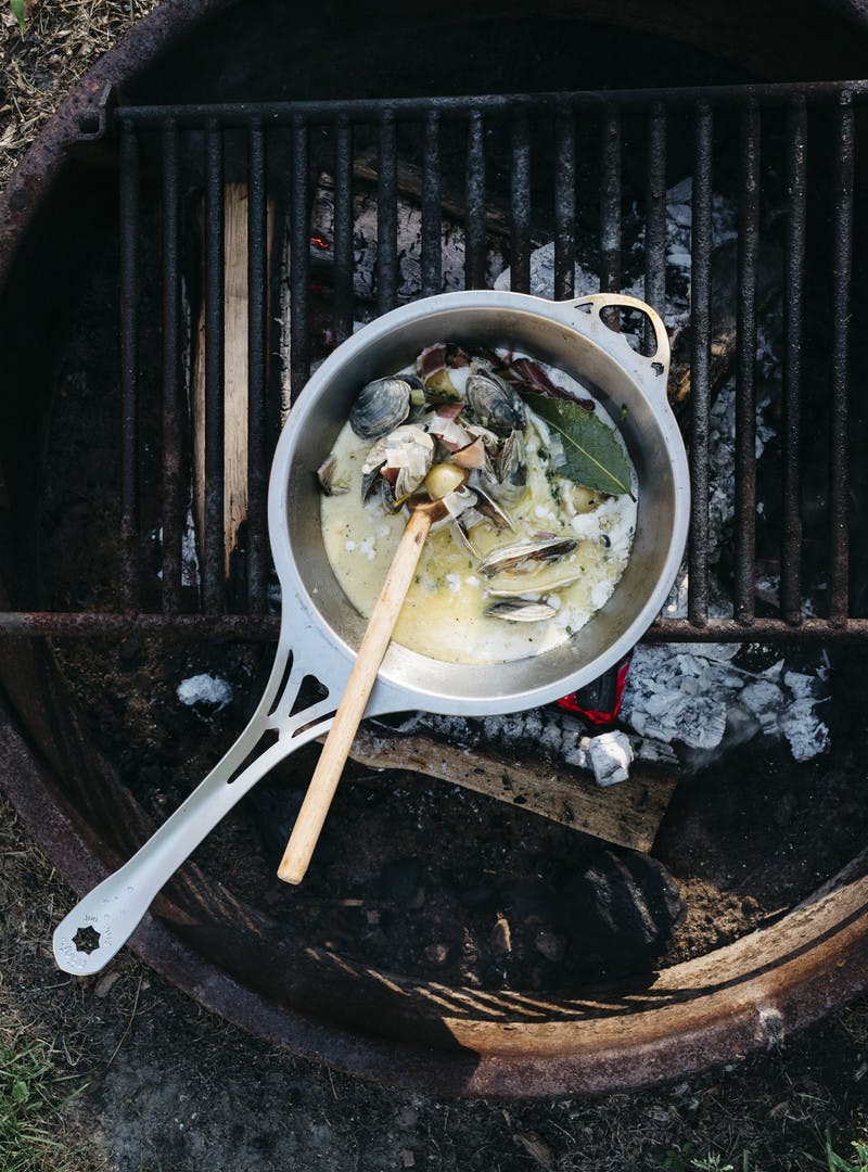 An overhead shot of the chowder cooking in a saucepan on the grill. 