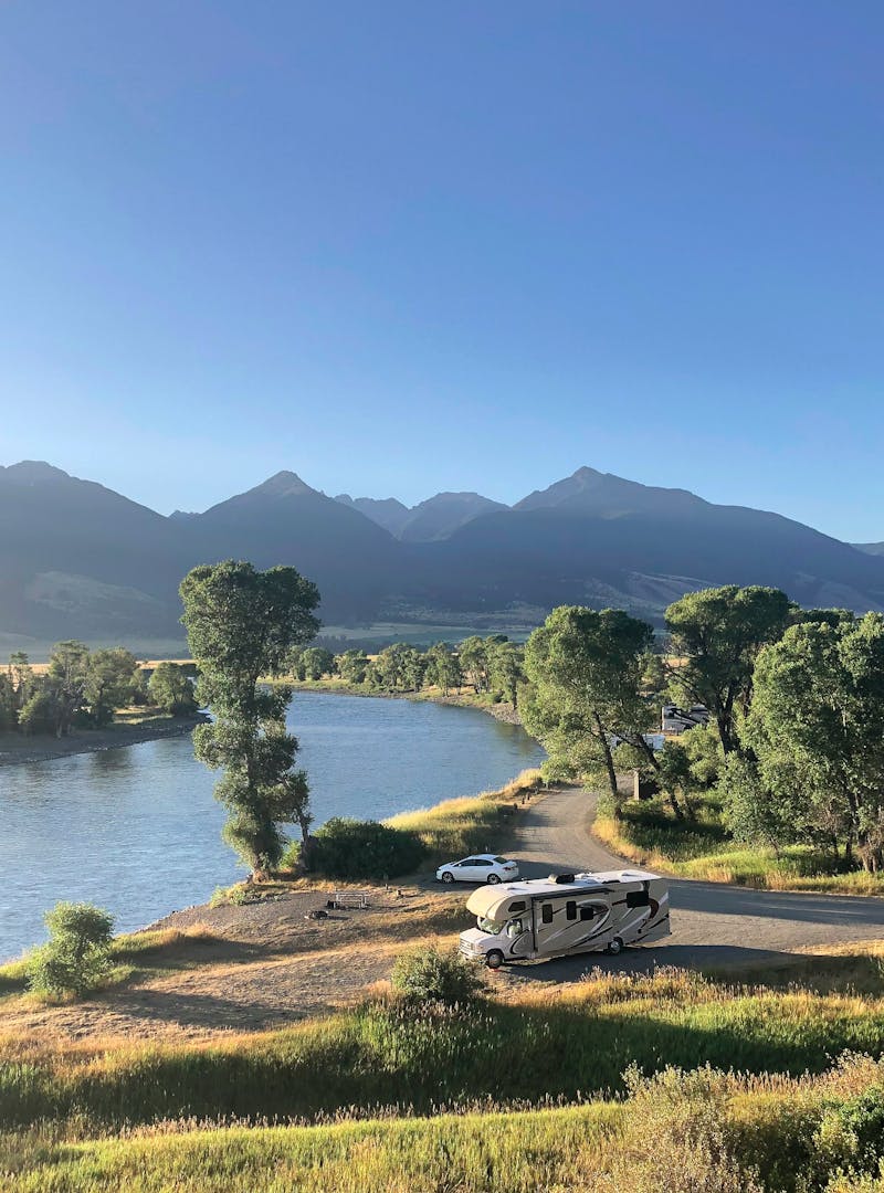 Sarah Hubbart's Thor Motor Coach Chateau parked by a lake with mountains in view.