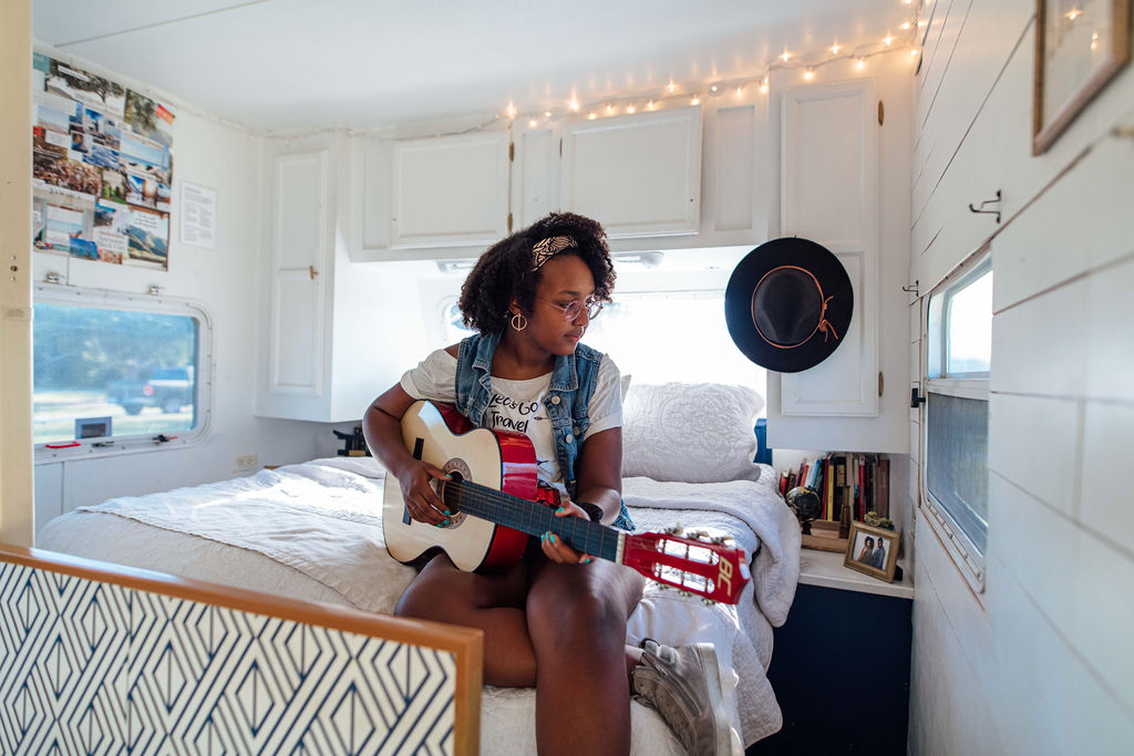 A teenage girl practicing the guitar.