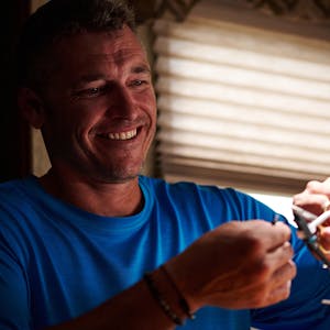 CHRIS HEUBLEIN working with fishing line inside his RV