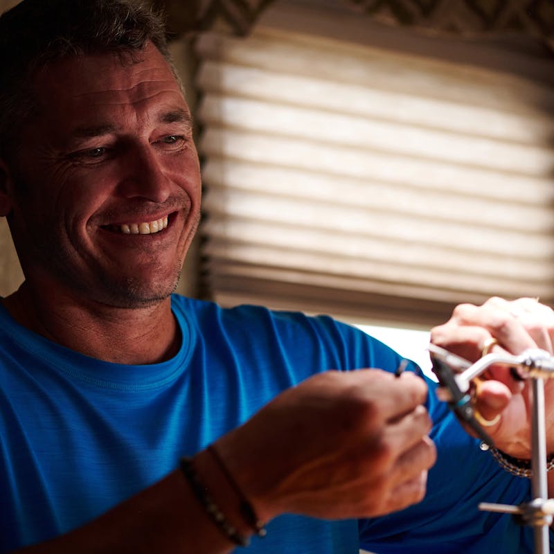 CHRIS HEUBLEIN working with fishing line inside his RV