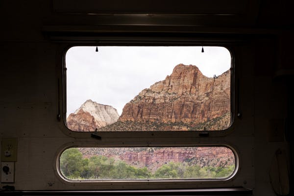 A beautiful view from inside an RV looking out the window to the mountains at Zion National Park.
