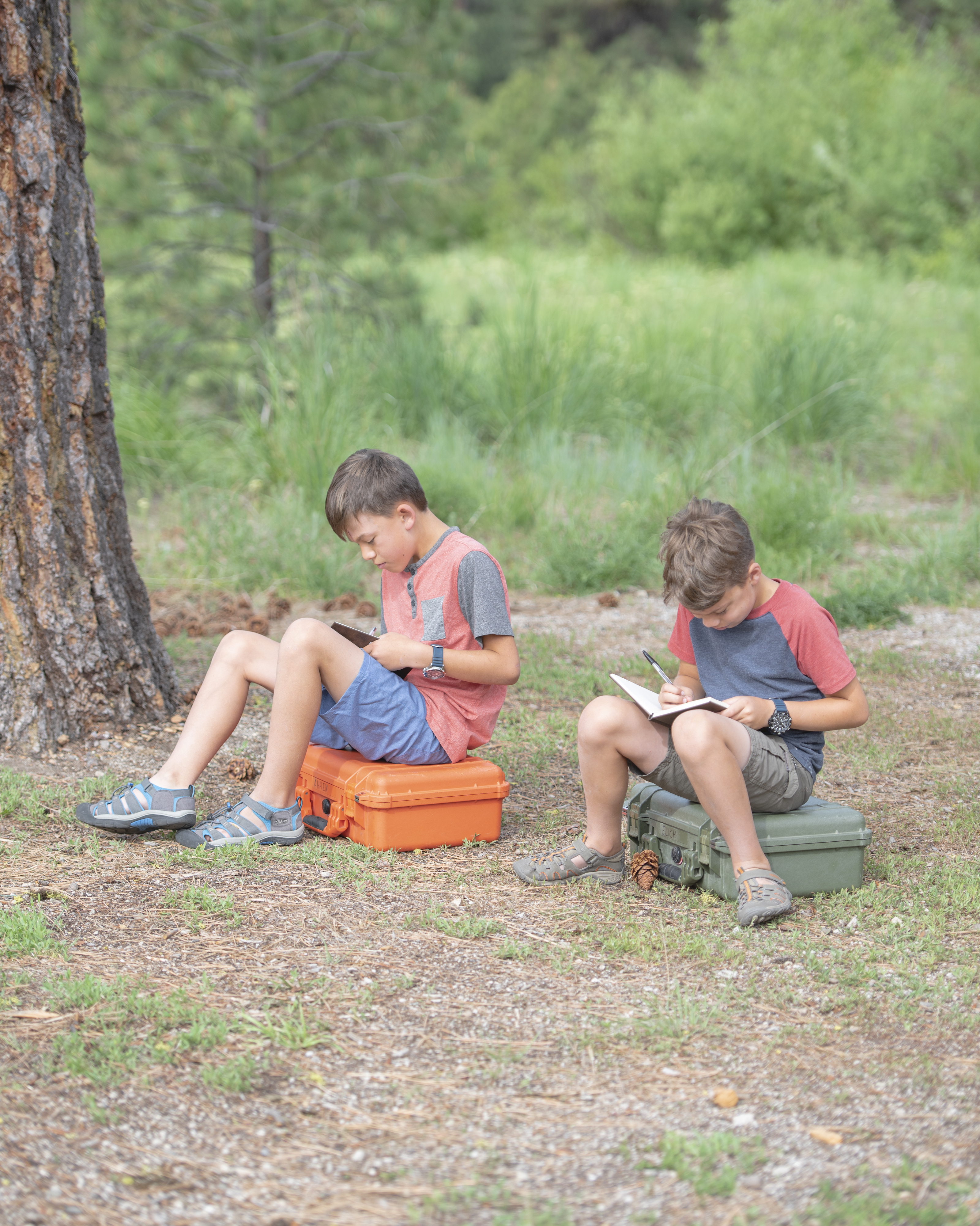 Chelsea Day's children writing in notebooks outside