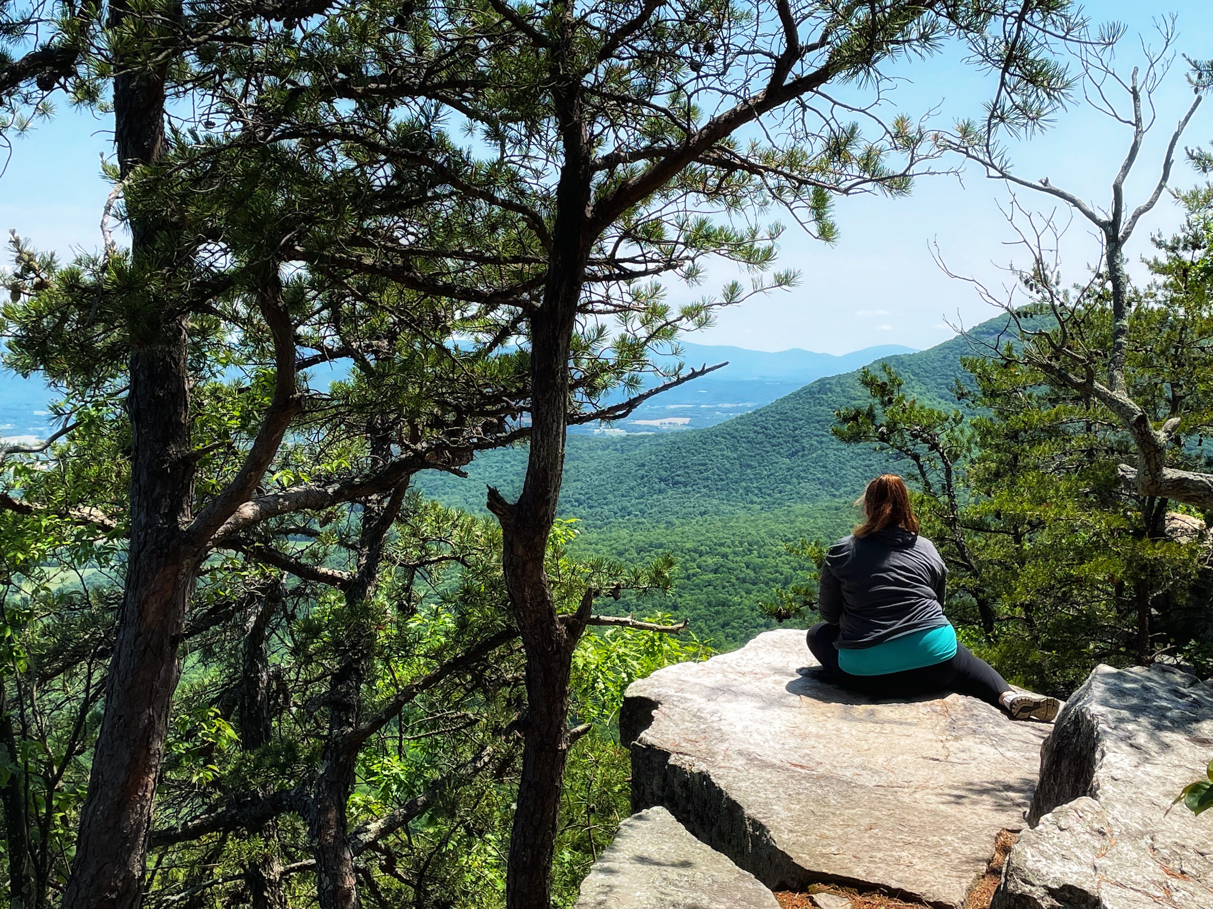 CHRISTINA MCMILLAN sitting on a rock in George Washington and Jefferson National Forest
