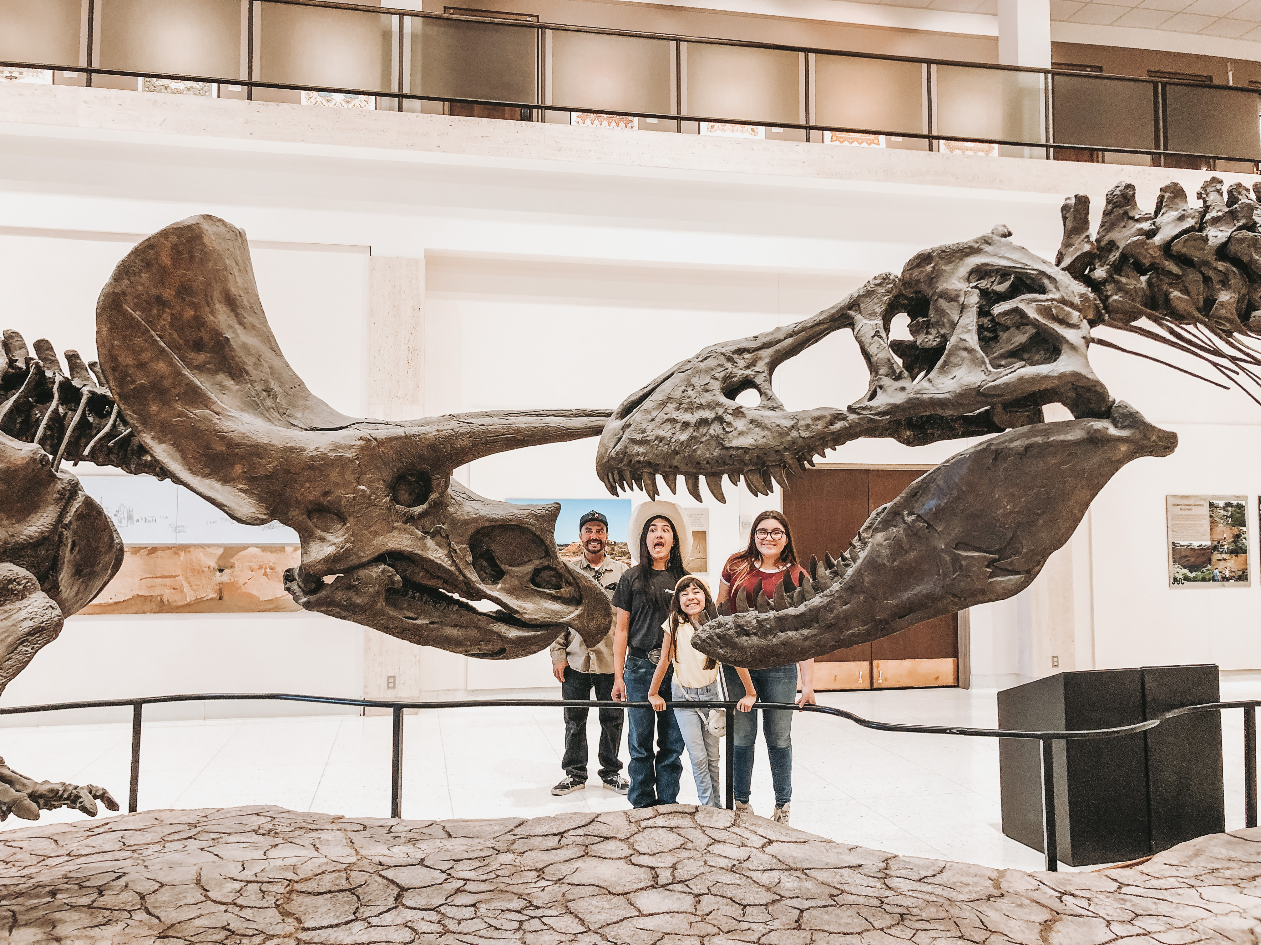 The O'Neill family standing with dinosaur bones at a museum. 