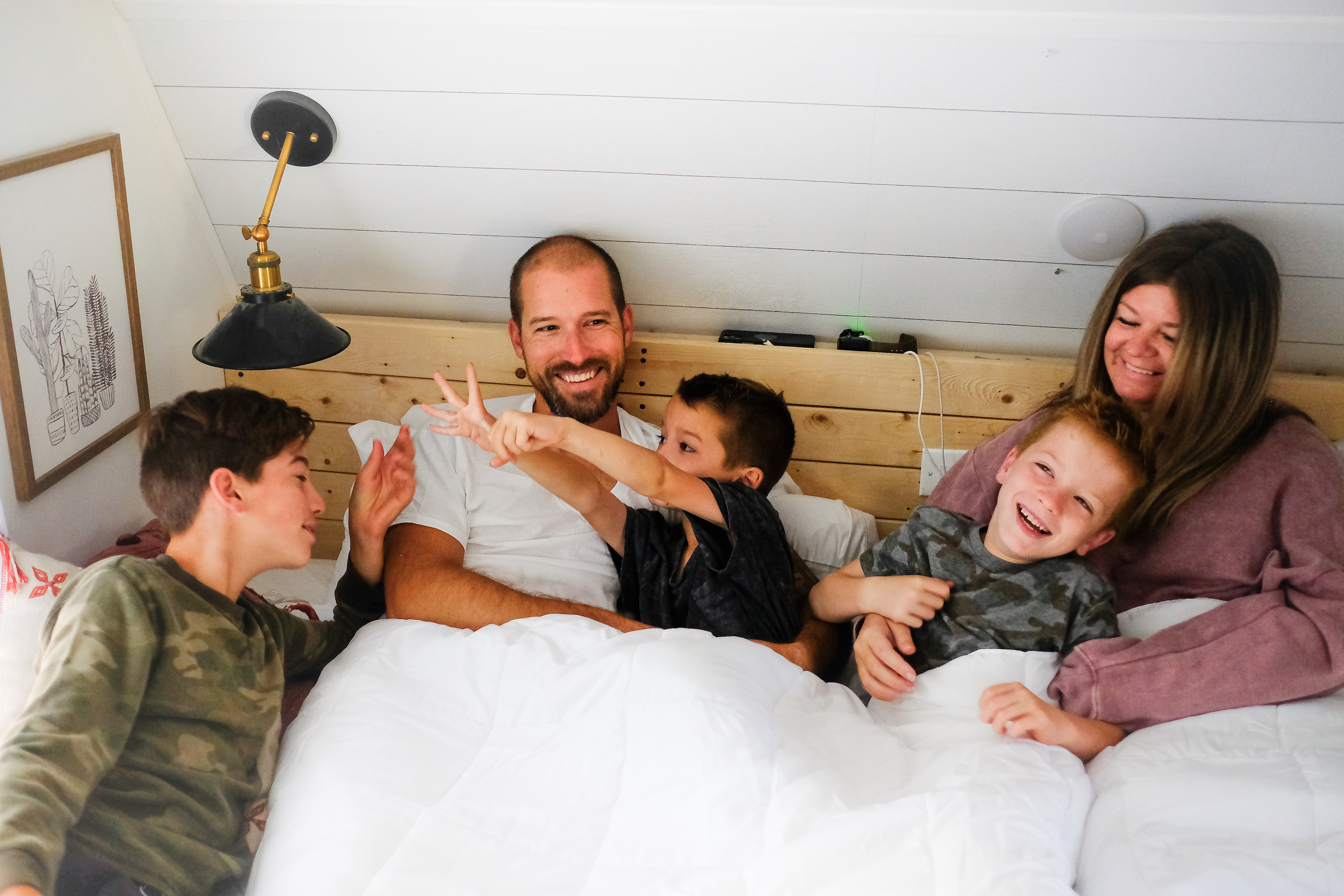 The Cutler family relaxes in bed in the morning.